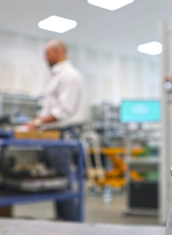 Close-up of electrode with CEO of Timm Stahlformenbau in the background