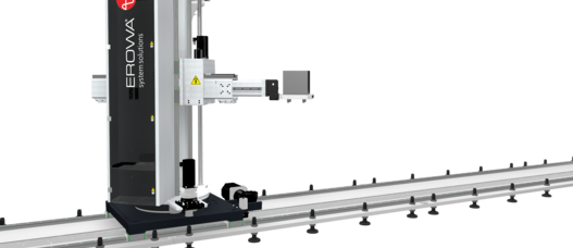 The EROWA Robot Dynamic transports workpieces along a linear rail in an automated manufacturing setup.